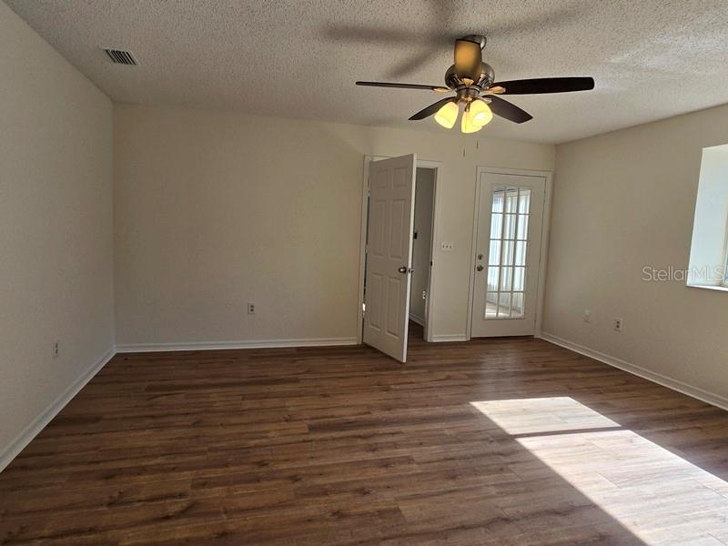 11510 Southwest 85th Court Ocala, FL 34481 - Photo 19 of 39 a view of an empty room with window and wooden floor