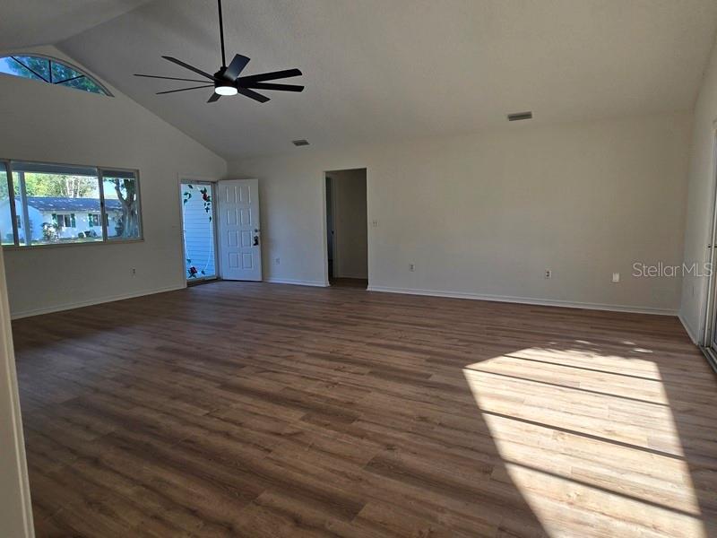11510 Southwest 85th Court Ocala, FL 34481 - Photo 20 of 39 a view of room with wooden floor and ceiling fan