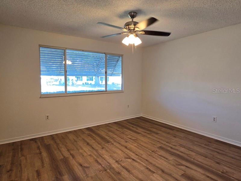 11510 Southwest 85th Court Ocala, FL 34481 - Photo 21 of 39 a view of a room with wooden floor and fan