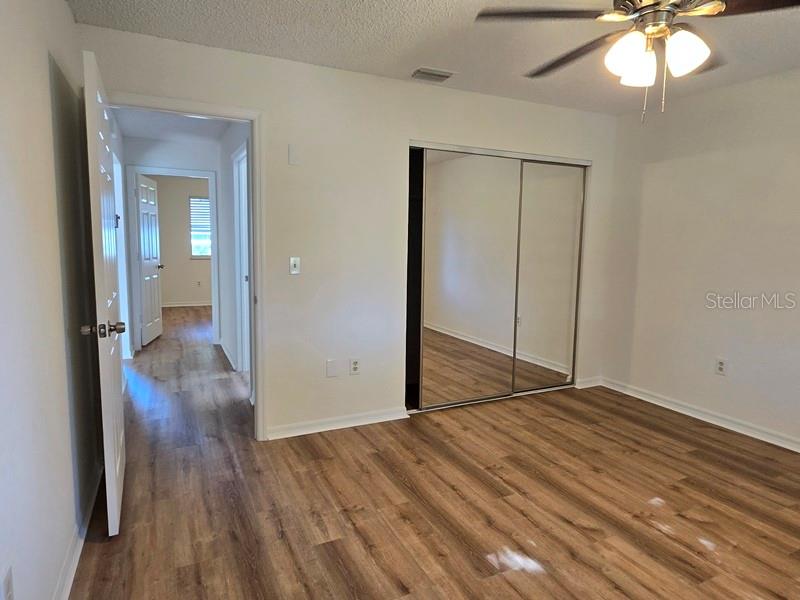 11510 Southwest 85th Court Ocala, FL 34481 - Photo 26 of 39 wooden floor in an empty room with a mirror