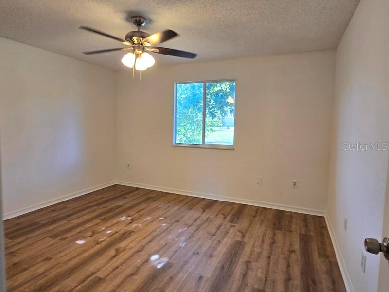11510 Southwest 85th Court Ocala, FL 34481 - Photo 27 of 39 wooden floor in an empty room with a window