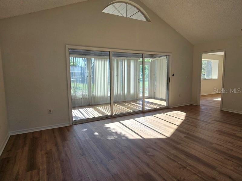 11510 Southwest 85th Court Ocala, FL 34481 - Photo 28 of 39 a view of an empty room with wooden floor and a window