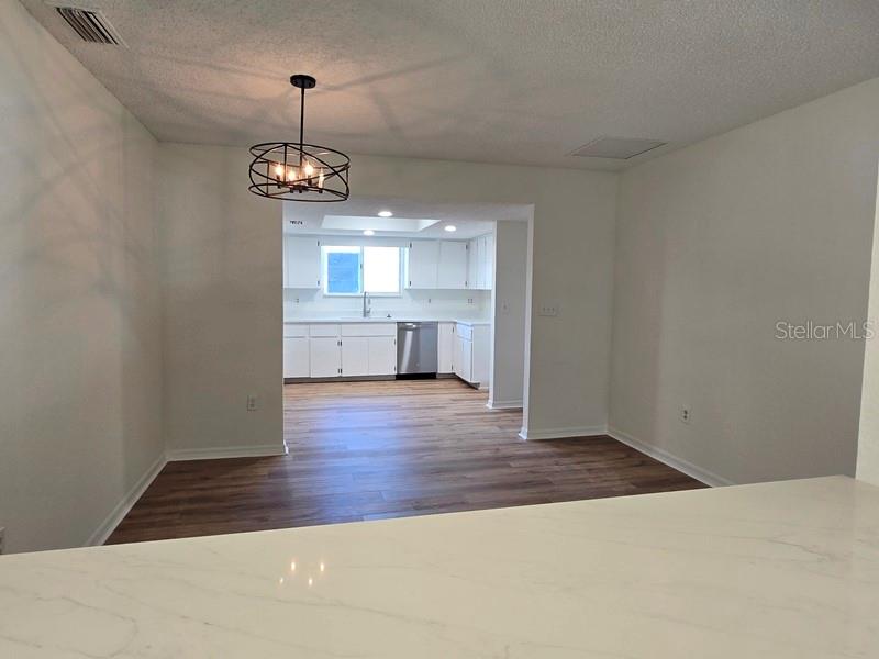 11510 Southwest 85th Court Ocala, FL 34481 - Photo 29 of 39 a view of a kitchen with a sink wooden cabinets and a refrigerator