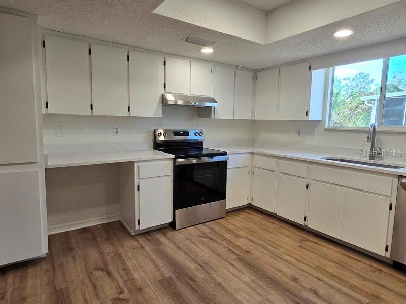 11510 Southwest 85th Court Ocala, FL 34481 - Photo 30 of 39 a kitchen with a sink a window and cabinets