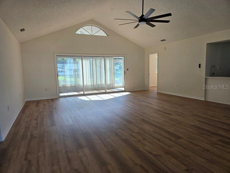 11510 Southwest 85th Court Ocala, FL 34481 - Photo 3 of 39 a view of an empty room with wooden floor and a window