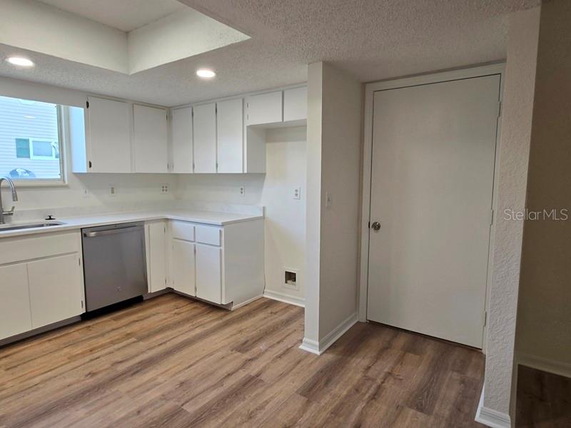 11510 Southwest 85th Court Ocala, FL 34481 - Photo 32 of 39 a kitchen with wooden floors and white walls