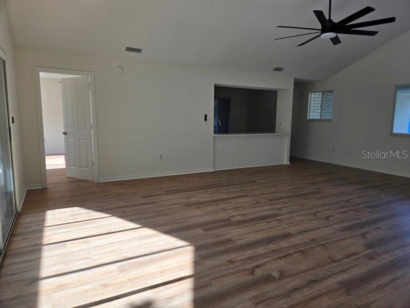 11510 Southwest 85th Court Ocala, FL 34481 - Photo 5 of 39 a view of an empty room with wooden floor and a window