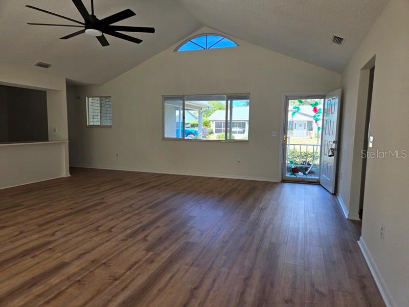 11510 Southwest 85th Court Ocala, FL 34481 - Photo 6 of 39 an empty room with wooden floor fan and windows