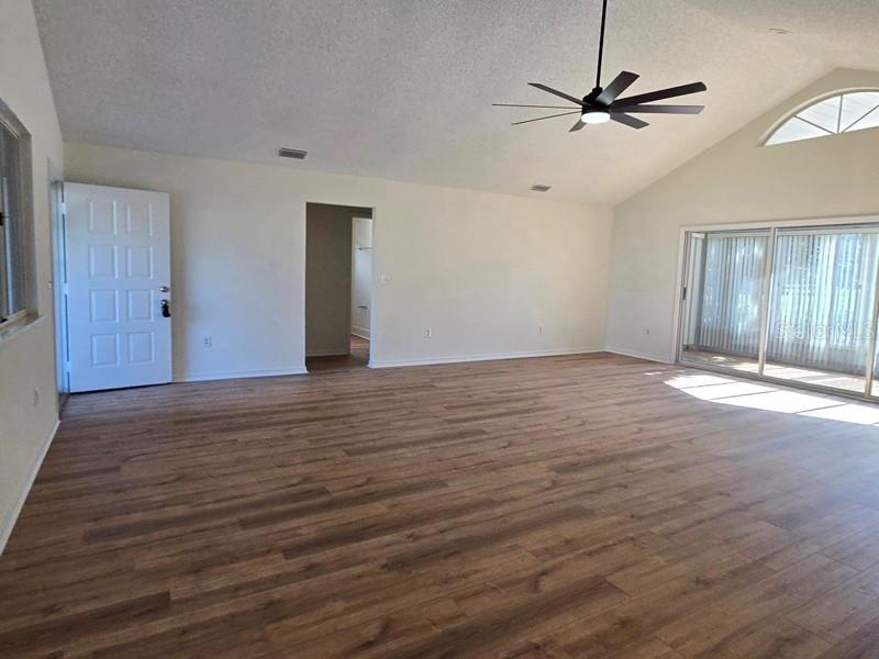 11510 Southwest 85th Court Ocala, FL 34481 - Photo 10 of 39 a view of an empty room with a window and wooden floor