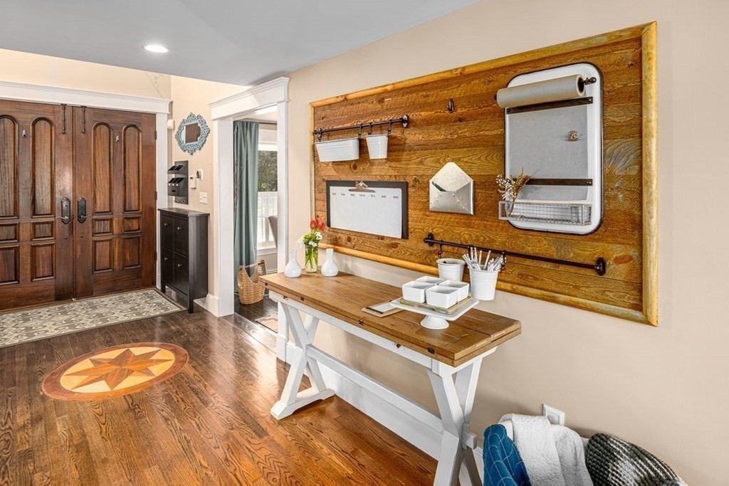 3 Cricket Circle Scituate, MA 02066 - Photo 16 of 42 a room with a table chairs and wooden floor