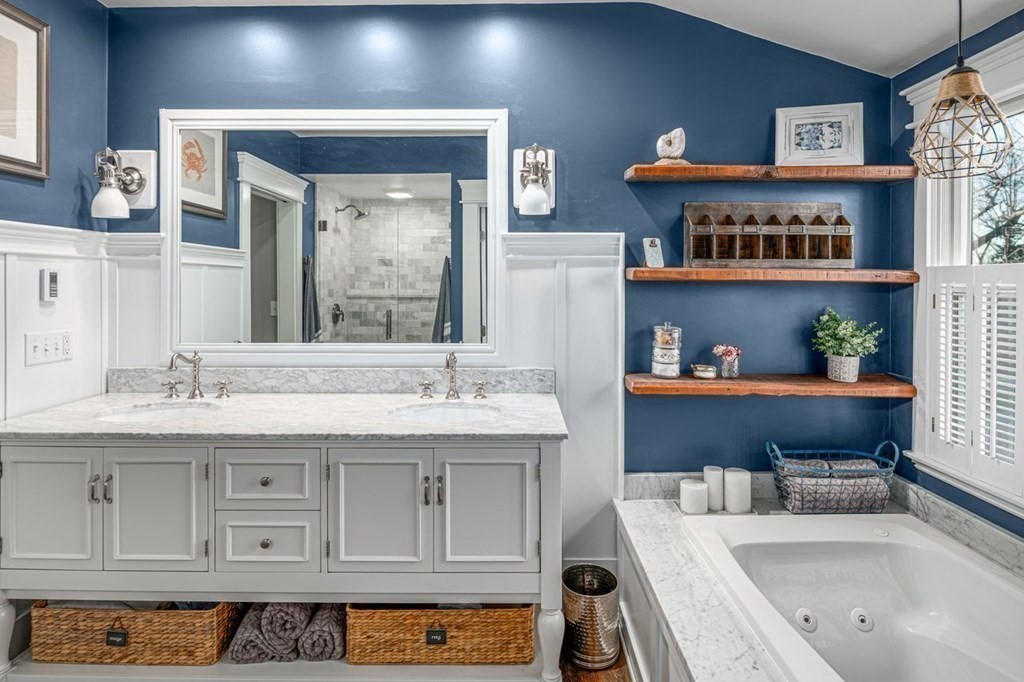 3 Cricket Circle Scituate, MA 02066 - Photo 20 of 42 a bathroom with a tub a sink and a large mirror
