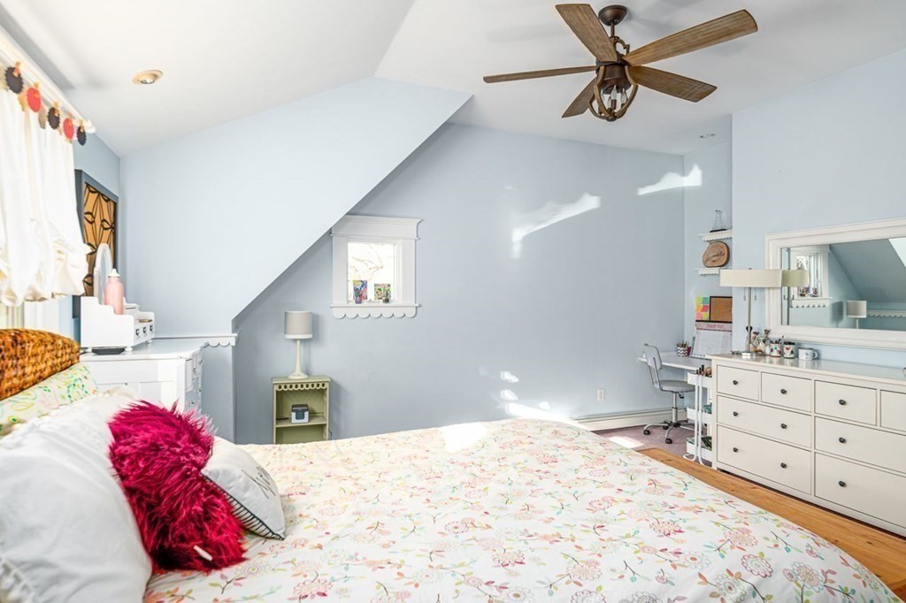 3 Cricket Circle Scituate, MA 02066 - Photo 24 of 42 a bedroom with a bed a chandelier and dresser