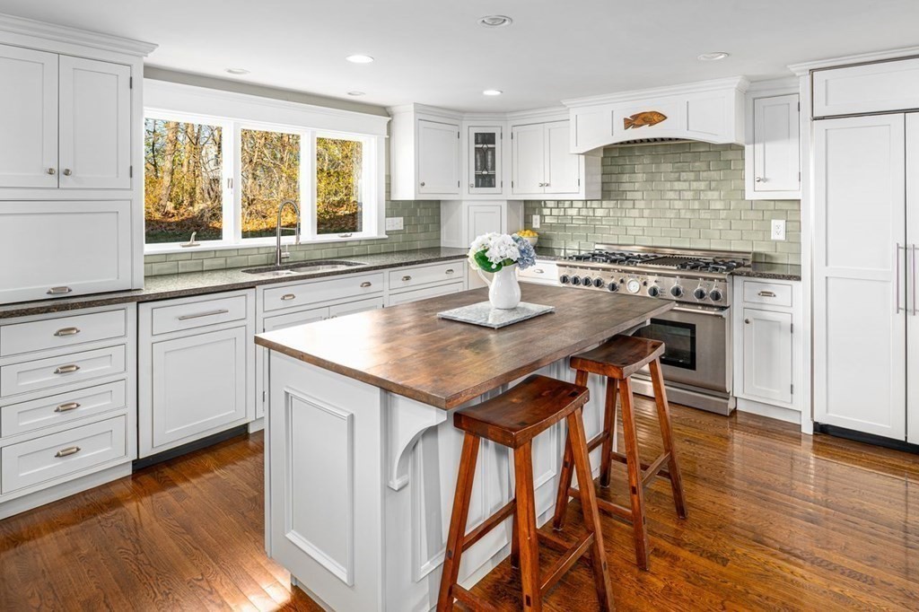 3 Cricket Circle Scituate, MA 02066 - Photo 3 of 42 a kitchen with granite countertop wooden floors and white appliances