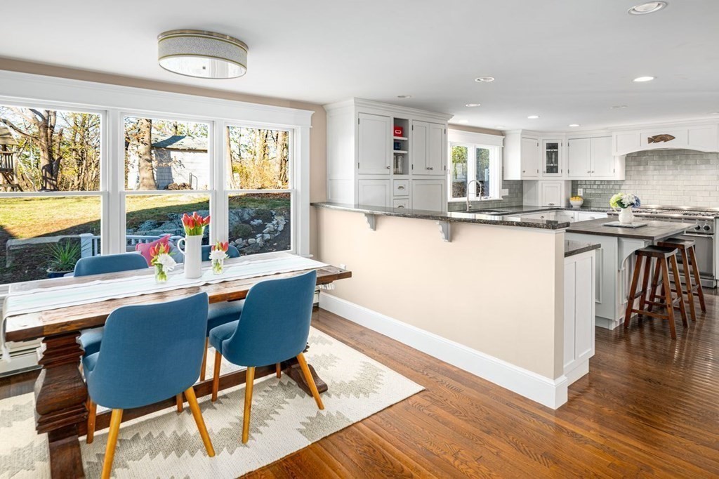 3 Cricket Circle Scituate, MA 02066 - Photo 4 of 42 a living room with stainless steel appliances granite countertop a table and chairs in it