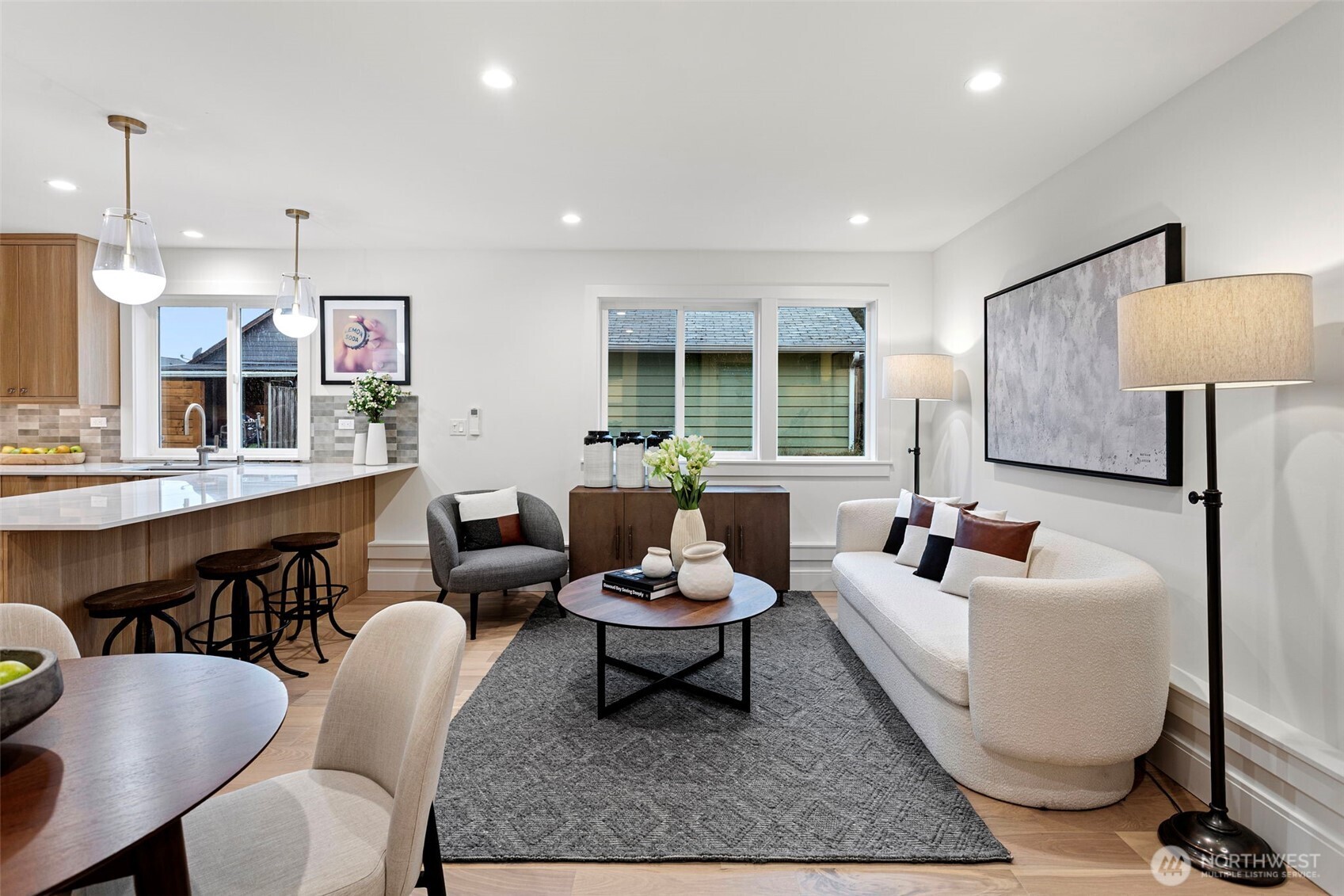 8003 25th Avenue Northwest Seattle, WA 98117 - Photo 12 of 25 a living room with furniture a rug and a chandelier