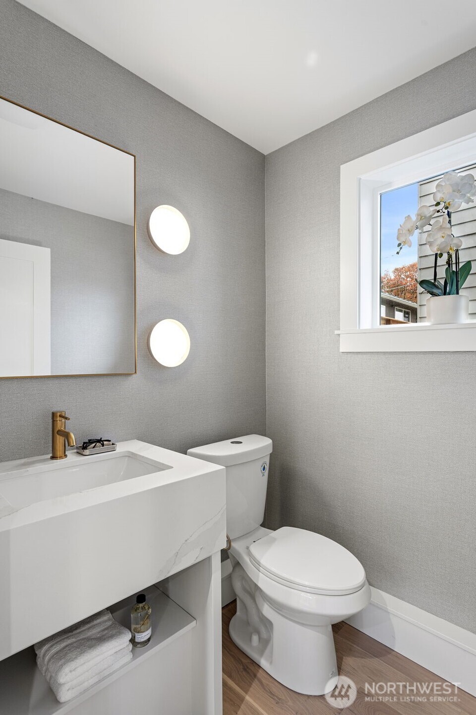 8003 25th Avenue Northwest Seattle, WA 98117 - Photo 16 of 25 a bathroom with a sink a toilet and a mirror