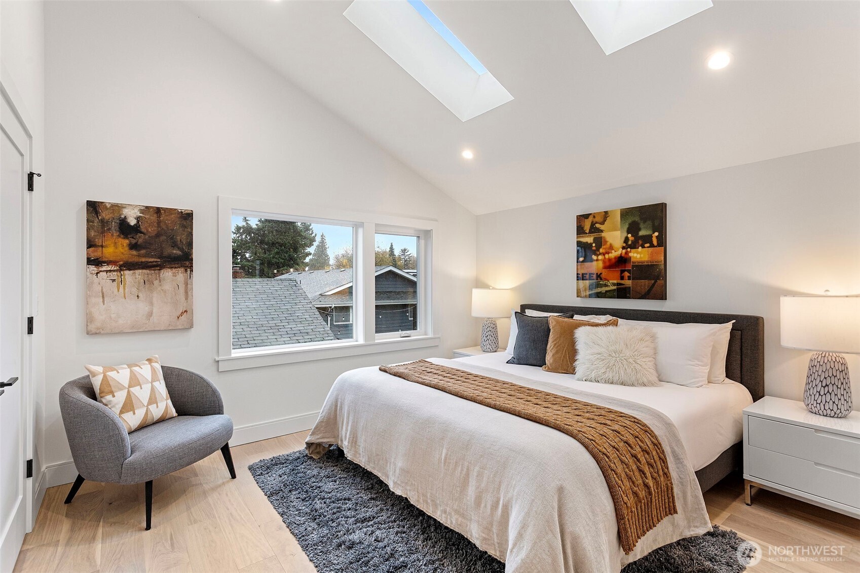 8003 25th Avenue Northwest Seattle, WA 98117 - Photo 18 of 25 a bedroom with a bed and glass window