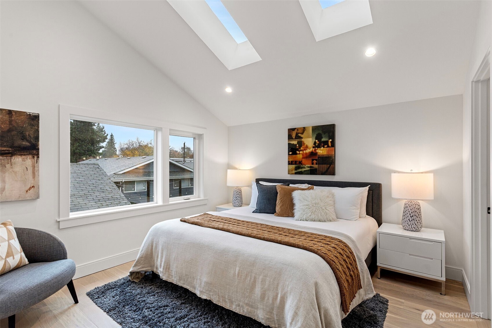 8003 25th Avenue Northwest Seattle, WA 98117 - Photo 19 of 25 a bedroom with a bed and glass window