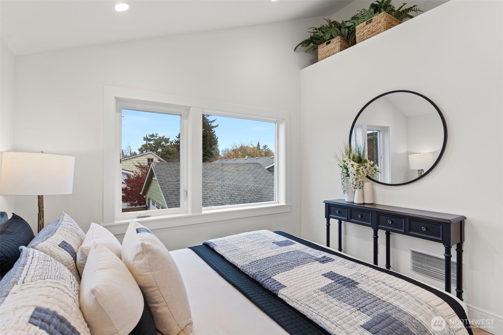 8003 25th Avenue Northwest Seattle, WA 98117 - Photo 23 of 25 a bedroom with a bed a mirror and a potted plant