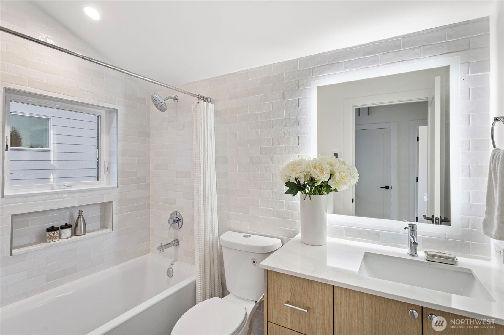 8003 25th Avenue Northwest Seattle, WA 98117 - Photo 24 of 25 a bathroom with a granite countertop sink mirror vanity bathtub and a toilet