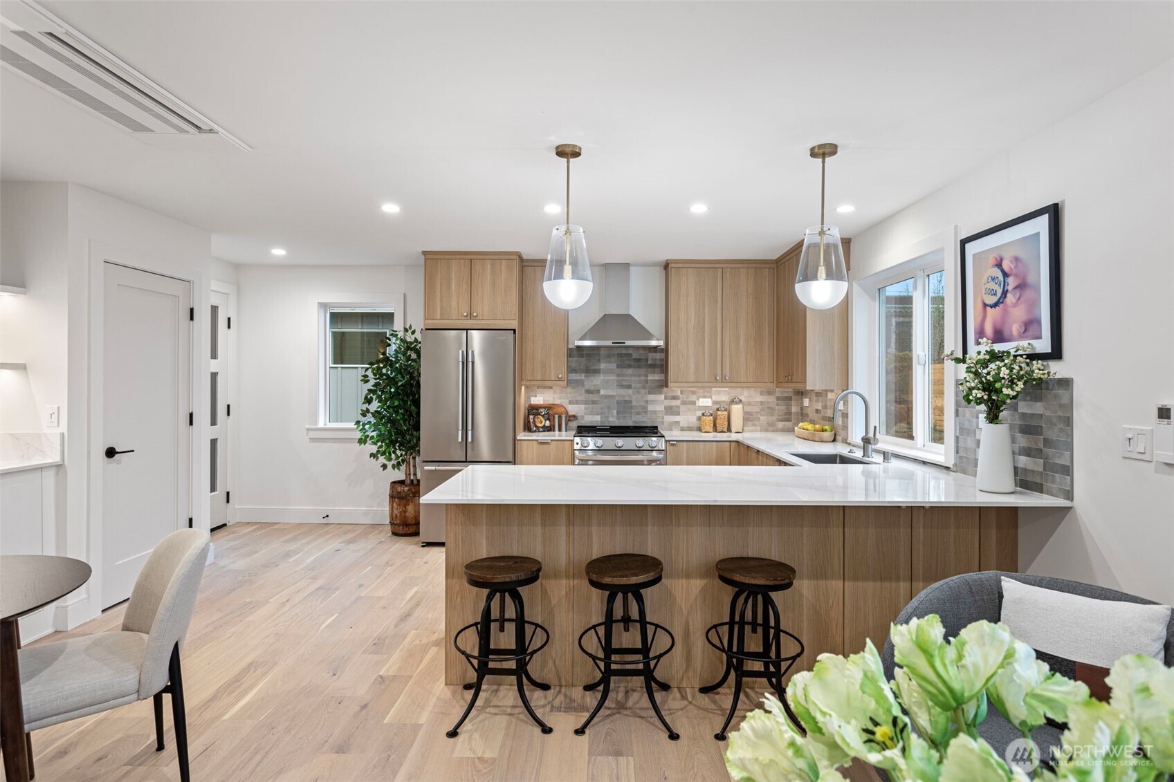 8003 25th Avenue Northwest Seattle, WA 98117 - Photo 5 of 25 a kitchen with kitchen island stainless steel appliances a dining table and chairs