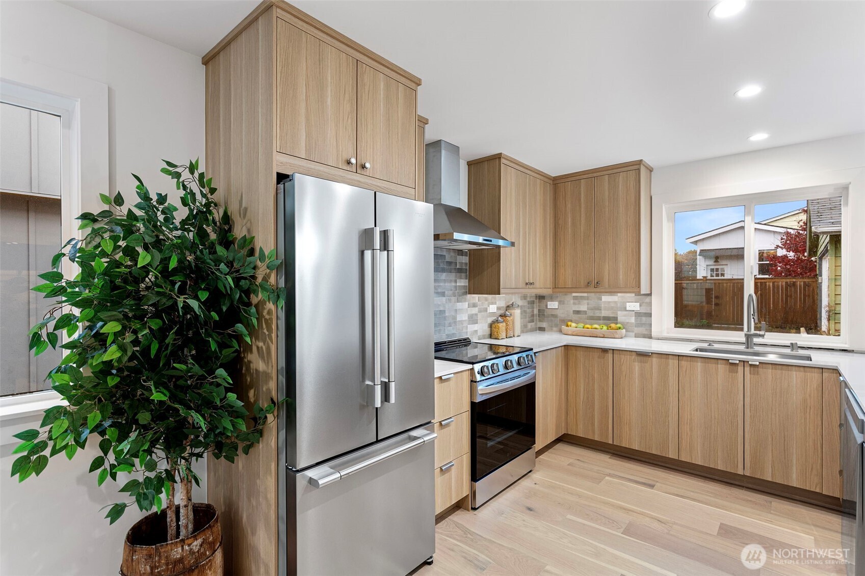 8003 25th Avenue Northwest Seattle, WA 98117 - Photo 6 of 25 a kitchen with stainless steel appliances a refrigerator and a sink