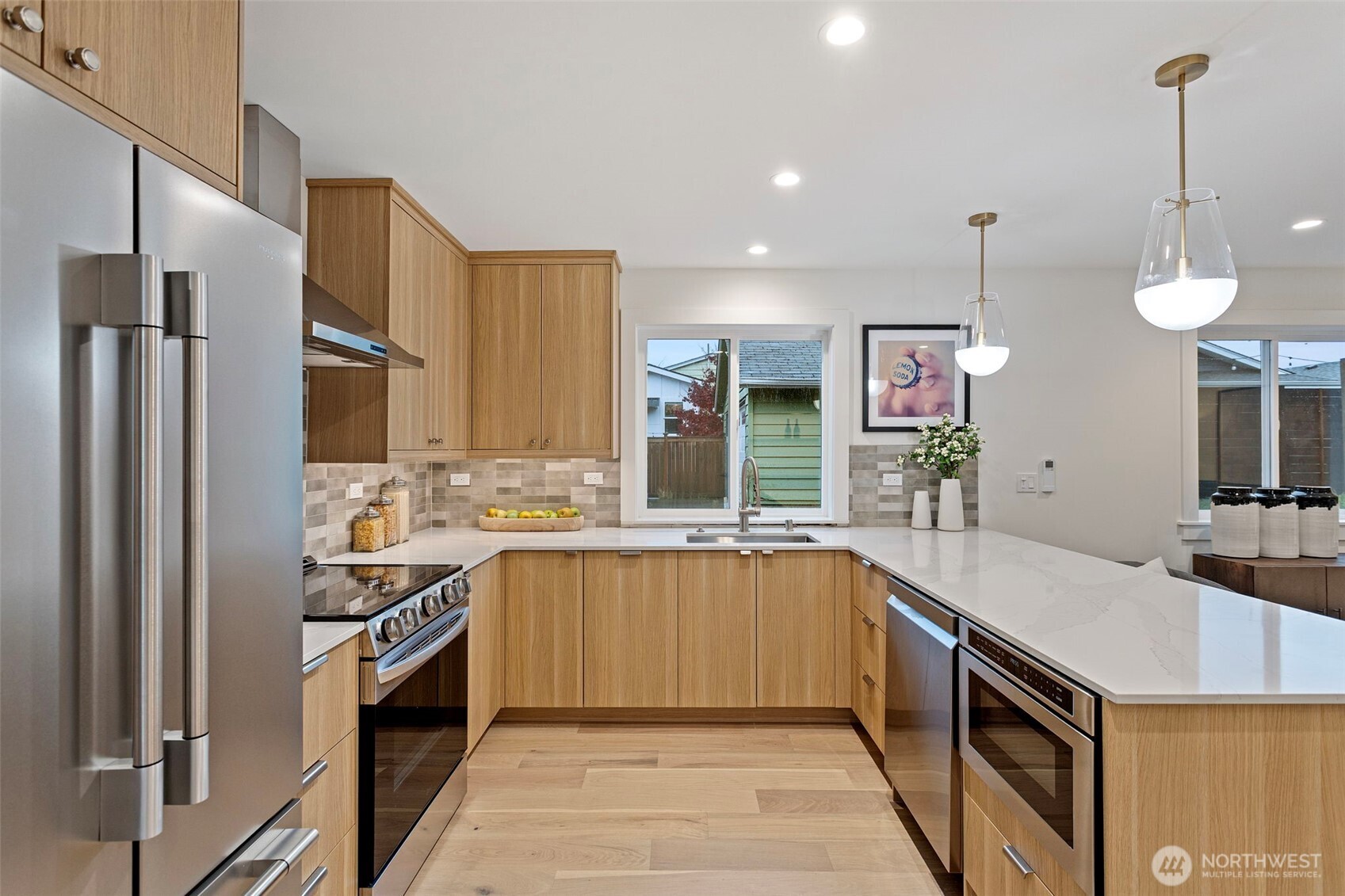 8003 25th Avenue Northwest Seattle, WA 98117 - Photo 8 of 25 a kitchen with stainless steel appliances a sink stove and refrigerator