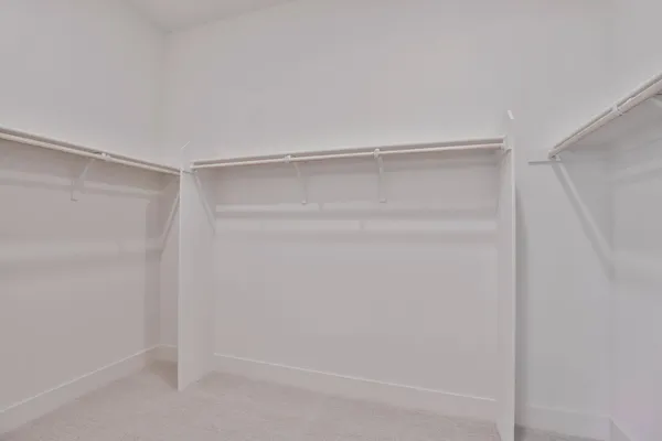a bedroom with a bed and a lamp
