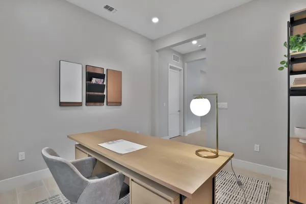 a bedroom with a bed and a lamp