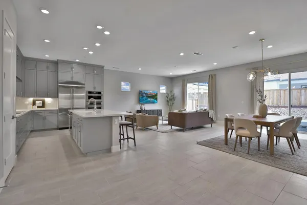 a kitchen with kitchen island cabinets and chairs in it