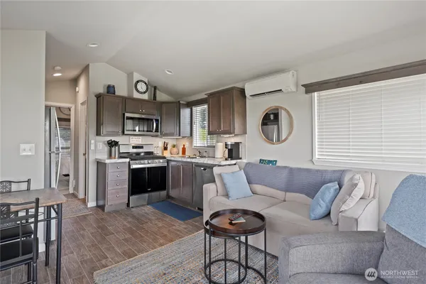 a kitchen with stainless steel appliances granite countertop a stove a sink and a microwave