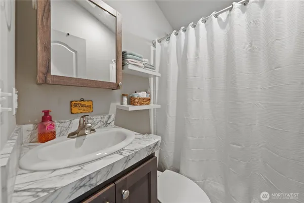 a bedroom with a bed and a lamp