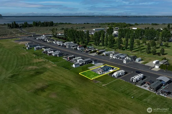 an aerial view of a city with ocean view in back