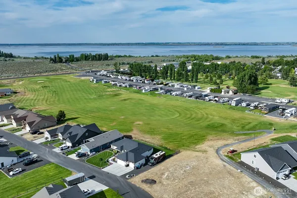 a view of a swimming pool and lounge chairs in the patio