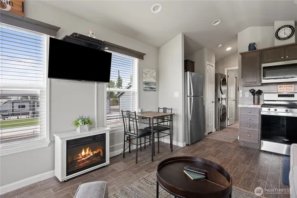 a living room with furniture a rug and a flat screen tv