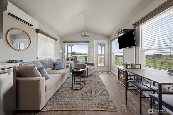 a living room with furniture and kitchen view