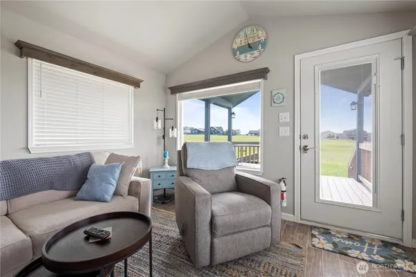 a living room with furniture a table and a large window