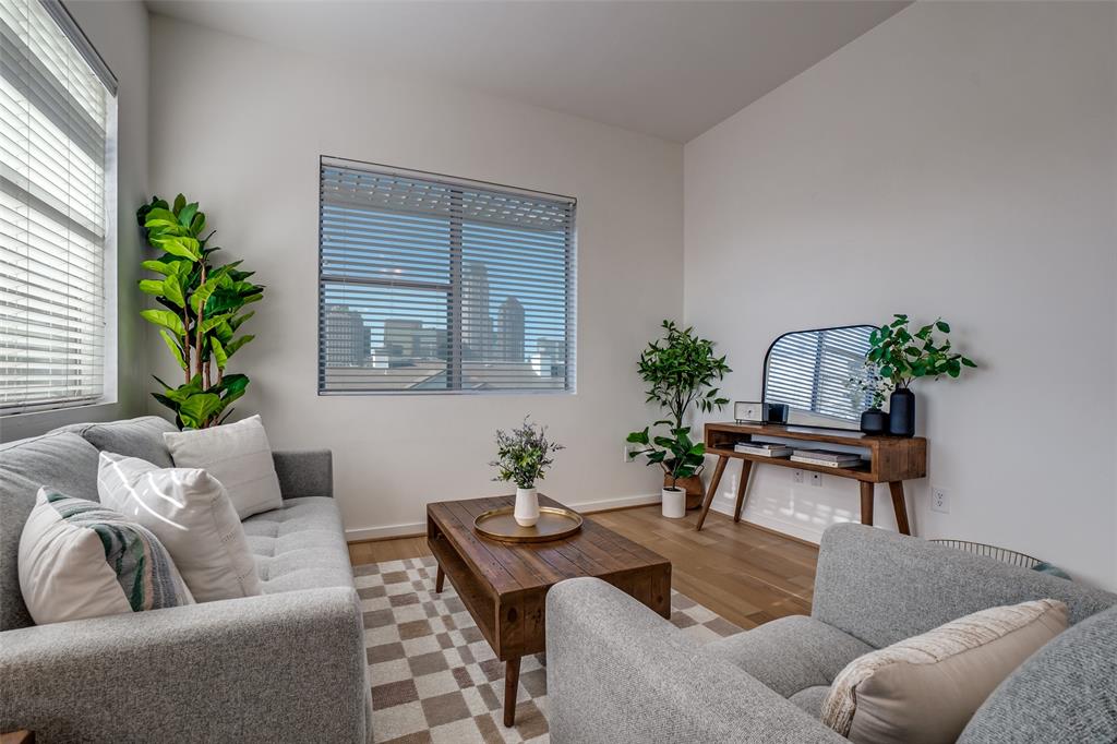 a living room with furniture and a potted plant