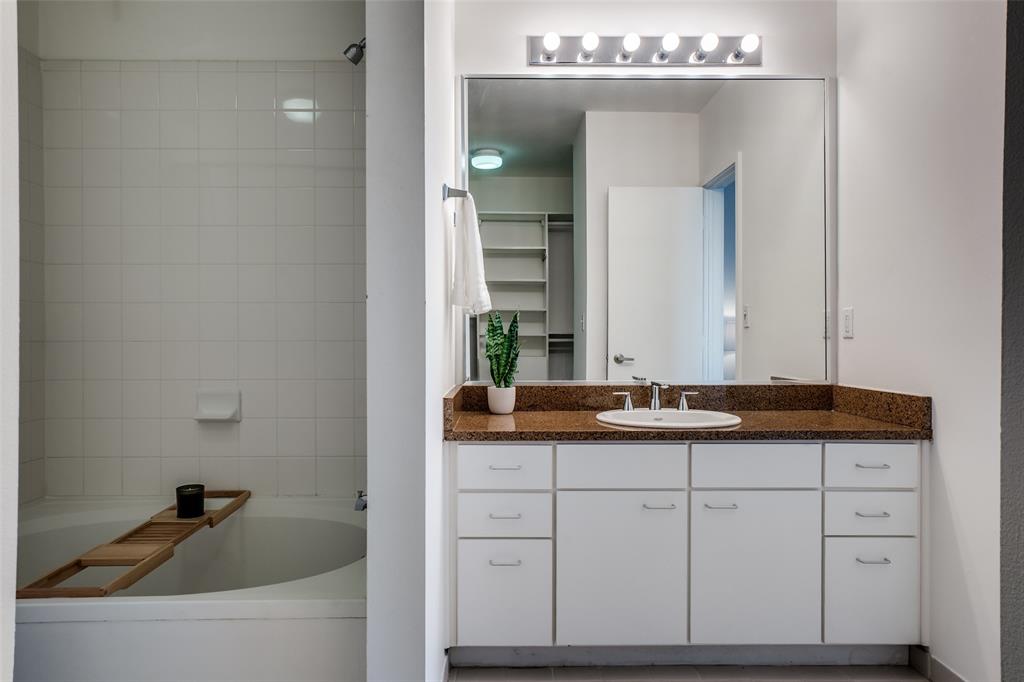 3015 Bryan Street, Unit 3B Dallas, TX 75204 - Photo 12 of 19 a bathroom with a granite countertop sink and a mirror