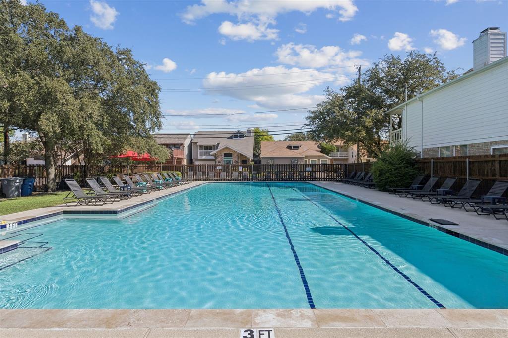 3015 Bryan Street, Unit 3B Dallas, TX 75204 - Photo 18 of 19 a view of a swimming pool with lawn chairs and a yard