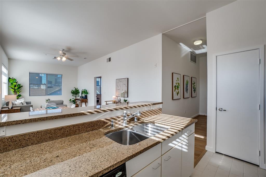 3015 Bryan Street, Unit 3B Dallas, TX 75204 - Photo 10 of 19 a living room with granite countertop furniture and a wooden floor