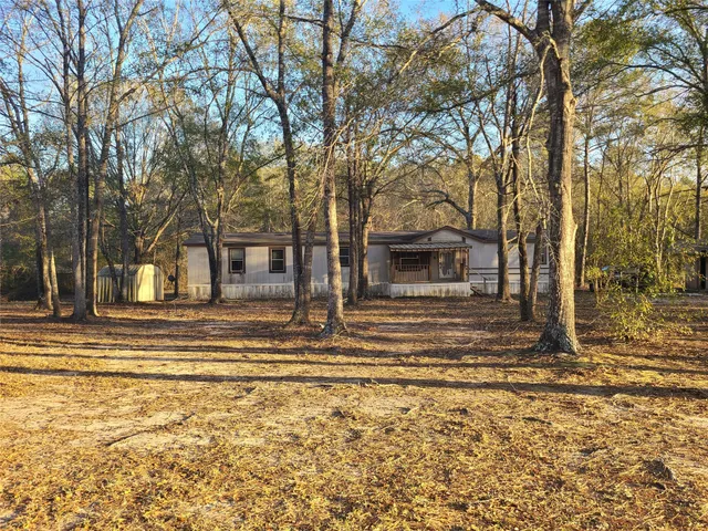a view of a house with a large tree