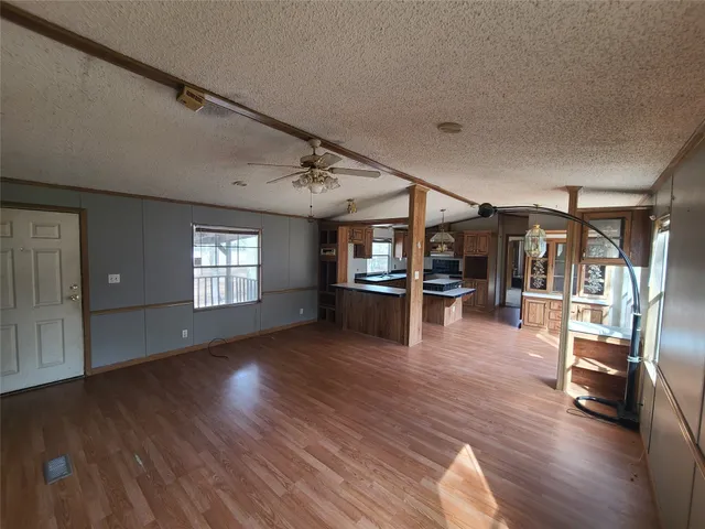 a view of a livingroom with wooden floor and windows