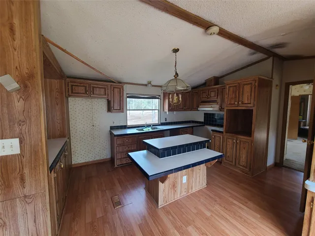 a living room with furniture and a kitchen view