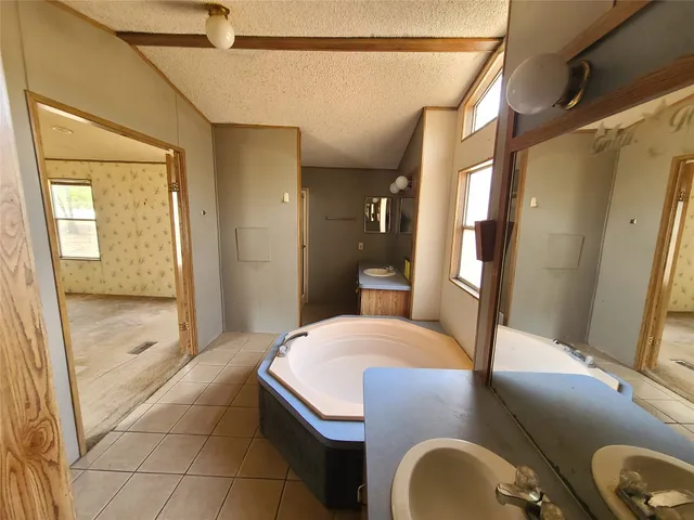 a bedroom with a bed and a mirror