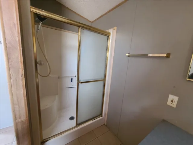 a bathroom with a glass shower door