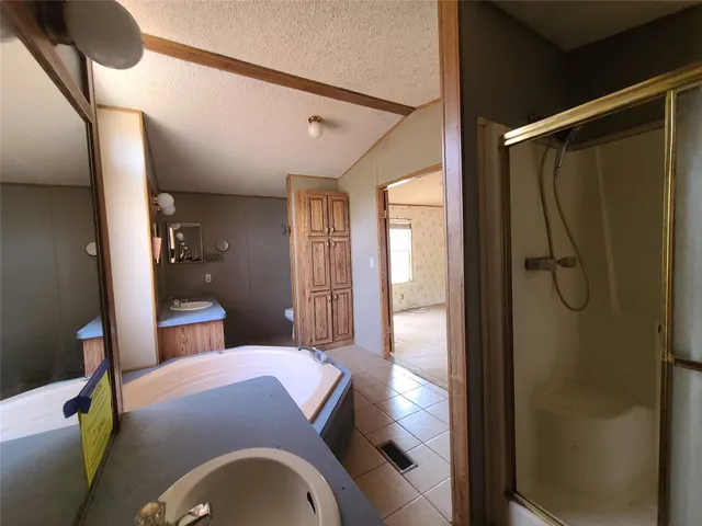 a bedroom with a bed and a mirror