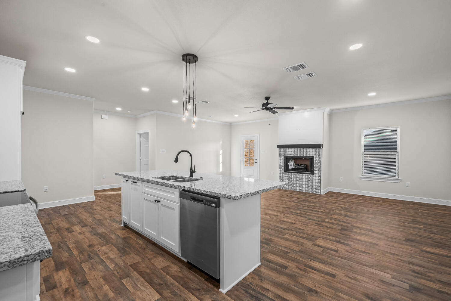 6923 17th Street Lubbock, TX 79416 - Photo 14 of 34 a large kitchen with stainless steel appliances granite countertop a sink a stove and a wooden floors