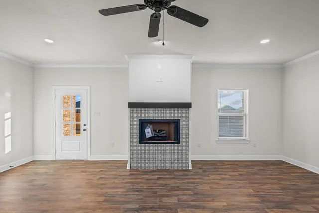 a view of a livingroom with a fireplace and window