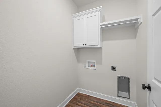 a view of storage and utility room with wooden floor